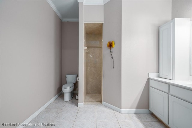 bathroom featuring tile patterned floors, crown molding, vanity, and tiled shower