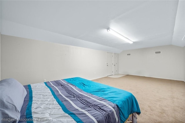 carpeted bedroom featuring vaulted ceiling