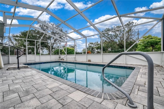 view of pool with a lanai and a patio area