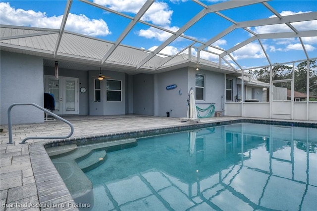 view of swimming pool with a patio and glass enclosure