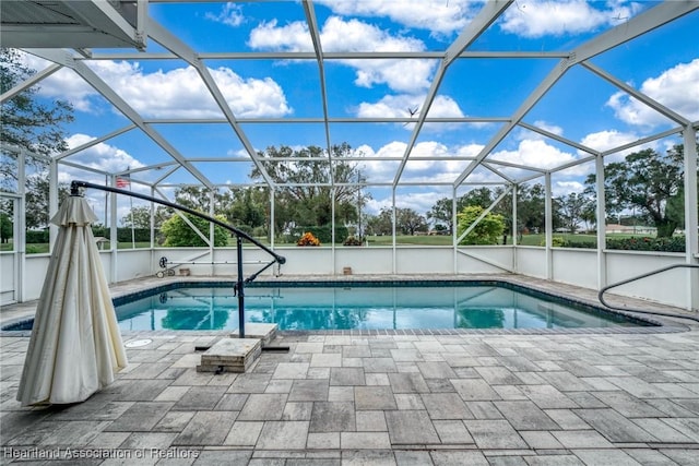 view of pool with a lanai and a patio