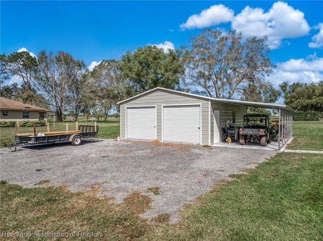 garage featuring a yard and a carport