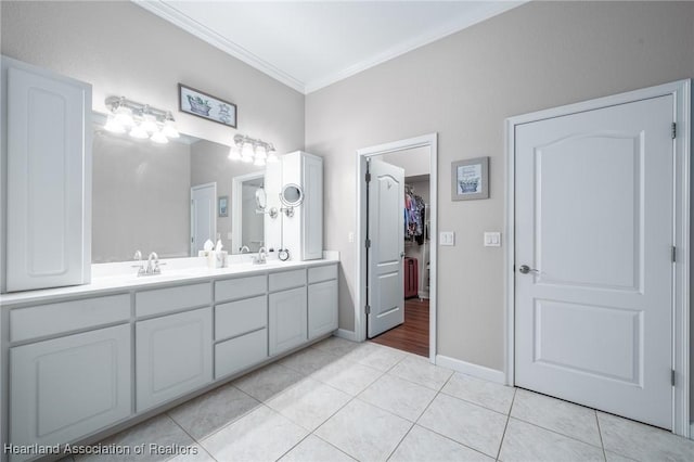 bathroom featuring tile patterned floors, vanity, and crown molding