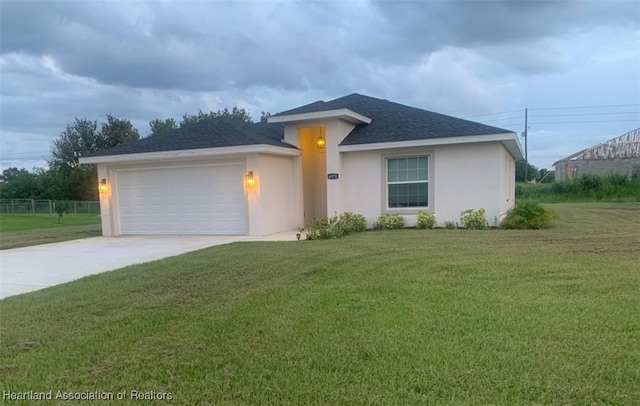 view of front of property featuring a front lawn and a garage