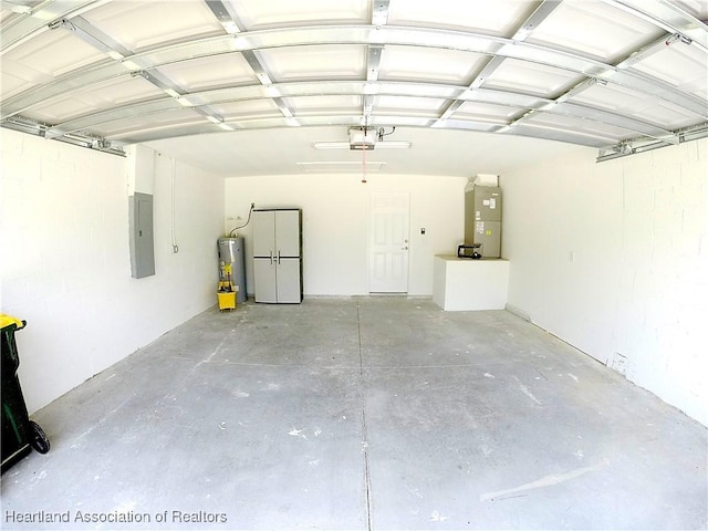 6978 Mexican Hat Dr, Sebring, FL 33872 - garage featuring electric panel, electric water heater, a garage door opener, and heating unit