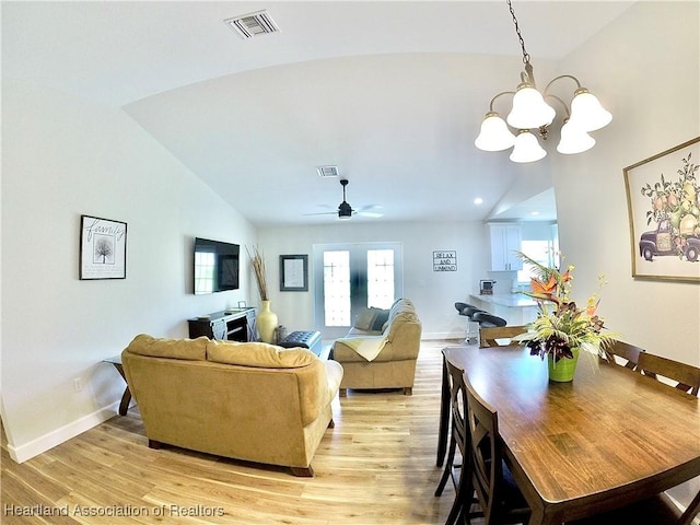 6978 Mexican Hat Dr, Sebring, FL 33872 - living area with vaulted ceiling, a chandelier, light wood finished floors, and a ceiling fan