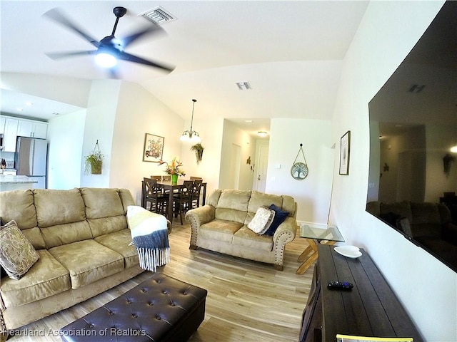 6978 Mexican Hat Dr, Sebring, FL 33872 - living room with lofted ceiling, light wood-style flooring, and ceiling fan