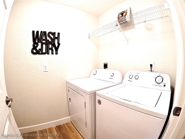6978 Mexican Hat Dr, Sebring, FL 33872 - laundry area featuring washing machine and clothes dryer and light wood-type flooring