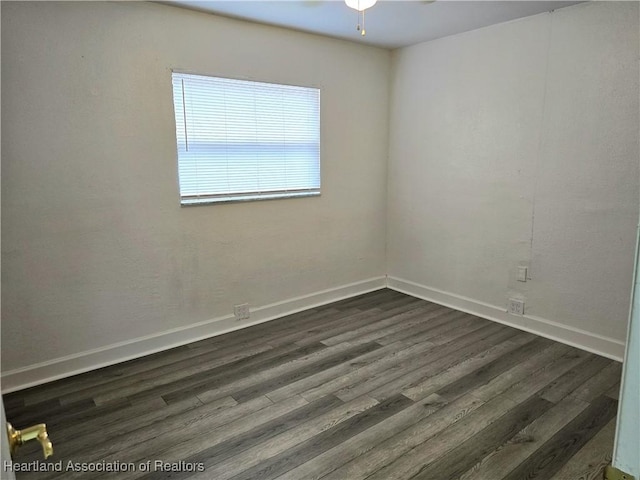 empty room featuring ceiling fan and dark hardwood / wood-style flooring