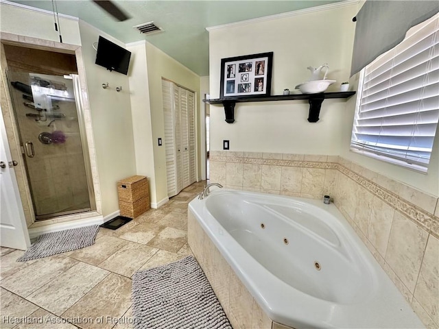 bathroom featuring a stall shower, baseboards, visible vents, and a whirlpool tub