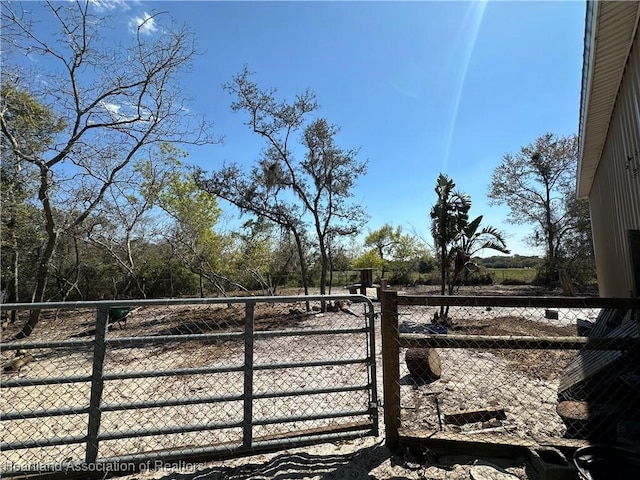 view of gate with fence