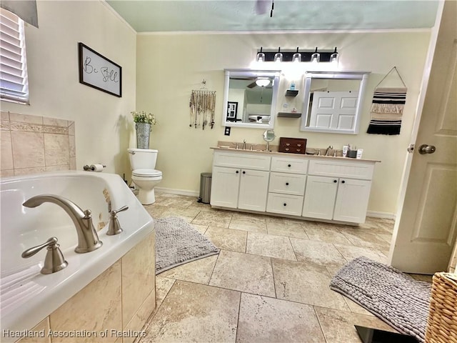 bathroom featuring toilet, a sink, a bath, double vanity, and crown molding