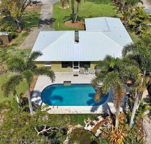 outdoor pool with a patio area