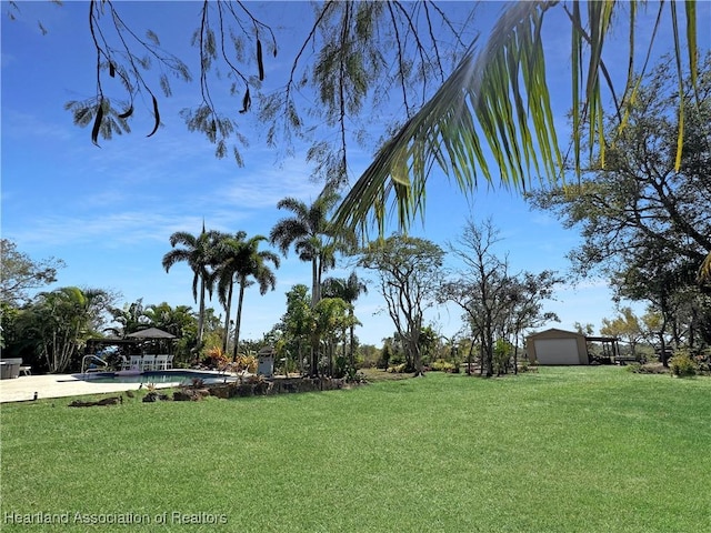 view of yard with an outbuilding and an outdoor pool