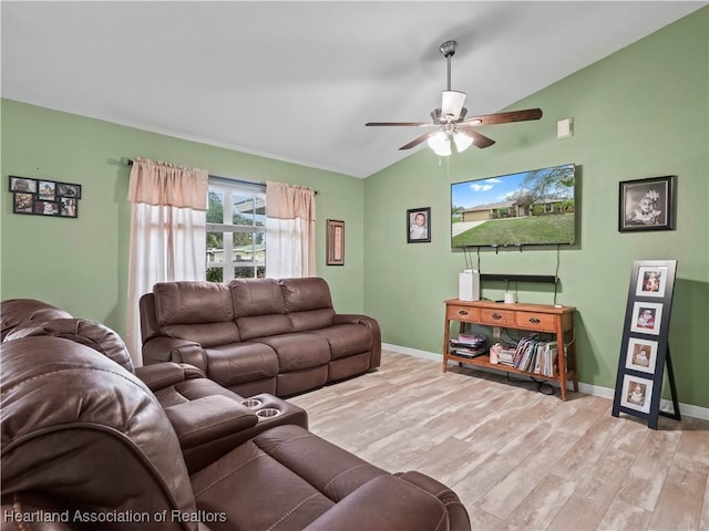 living room featuring lofted ceiling, light wood-type flooring, and ceiling fan