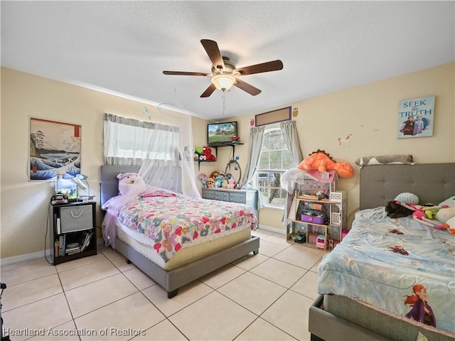 bedroom with ceiling fan and light tile patterned flooring