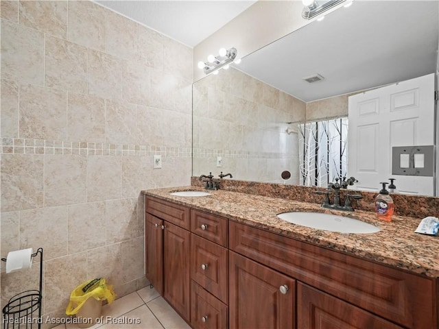 bathroom with tile walls, tile patterned floors, vanity, and a shower with shower curtain