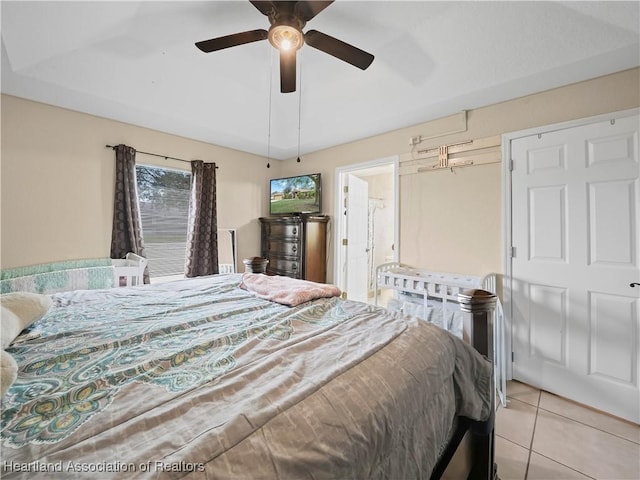 bedroom with ceiling fan and light tile patterned floors