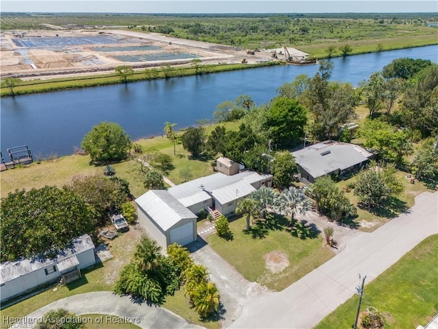 ranch-style home with a garage, an outdoor structure, and a front lawn