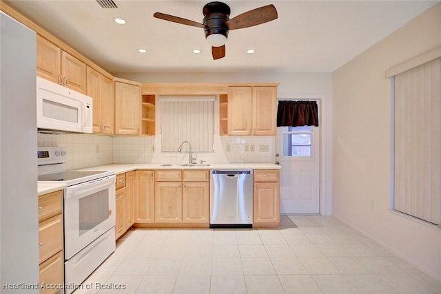 kitchen with light brown cabinets, white appliances, backsplash, and sink