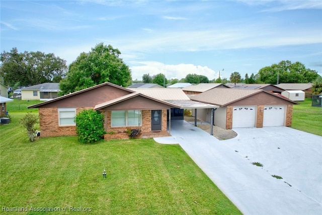 ranch-style house featuring a carport, a garage, and a front lawn