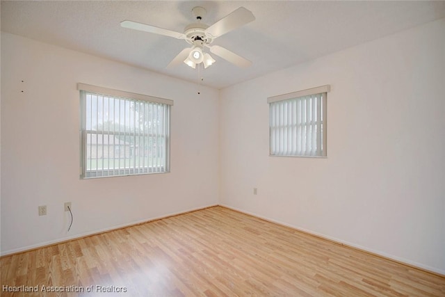 empty room featuring ceiling fan and light hardwood / wood-style floors