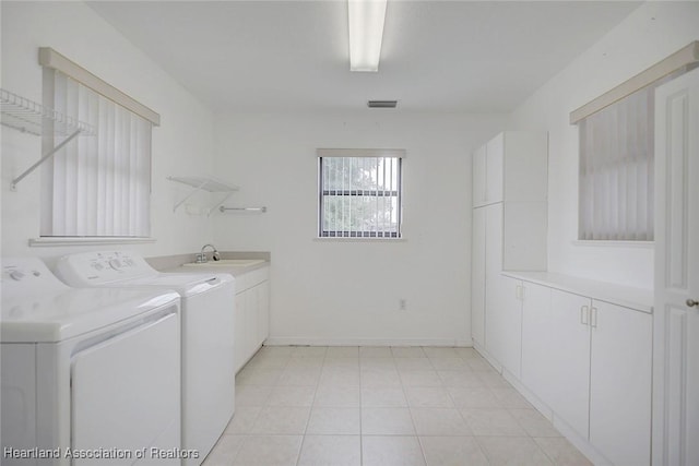 laundry room with cabinets, independent washer and dryer, and sink