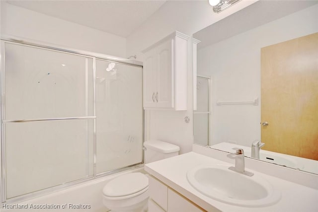 full bathroom featuring toilet, vanity, and combined bath / shower with glass door