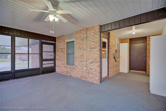 unfurnished sunroom with ceiling fan