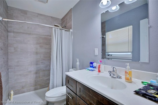 bathroom featuring vanity, toilet, and a shower with shower curtain