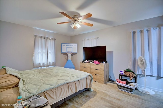 bedroom with ceiling fan and light wood-type flooring