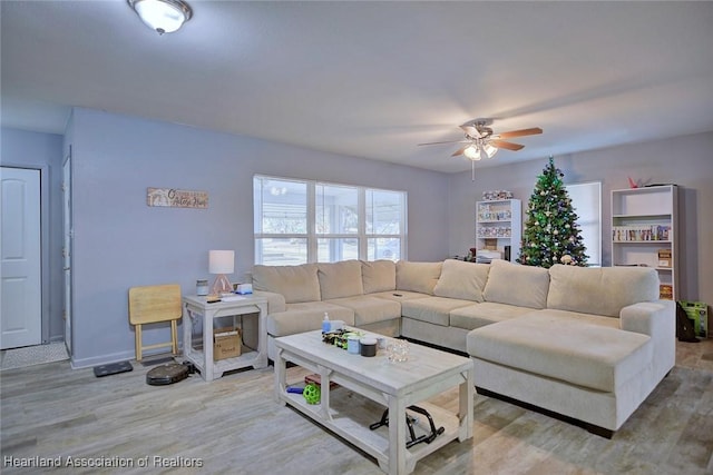 living room with ceiling fan and hardwood / wood-style floors