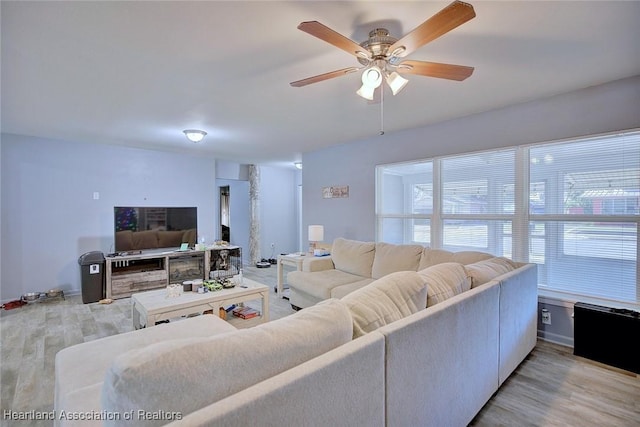 living room featuring ceiling fan and light wood-type flooring