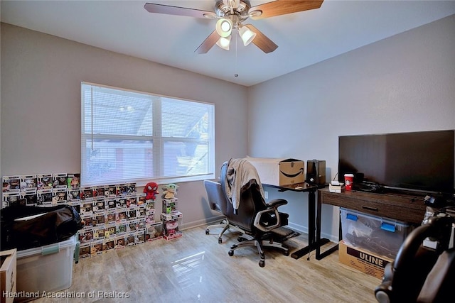 home office featuring light hardwood / wood-style floors and ceiling fan