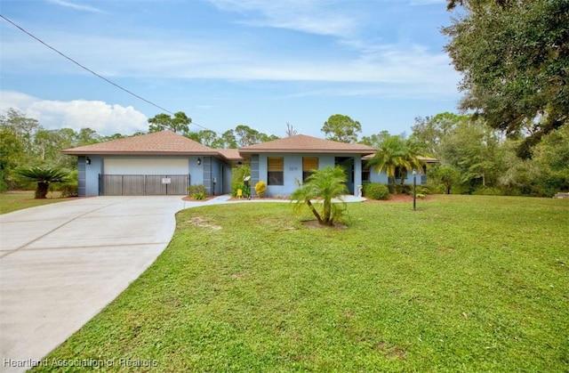 ranch-style home featuring a garage and a front yard