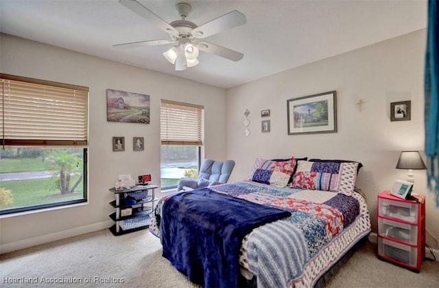 bedroom with ceiling fan and light colored carpet