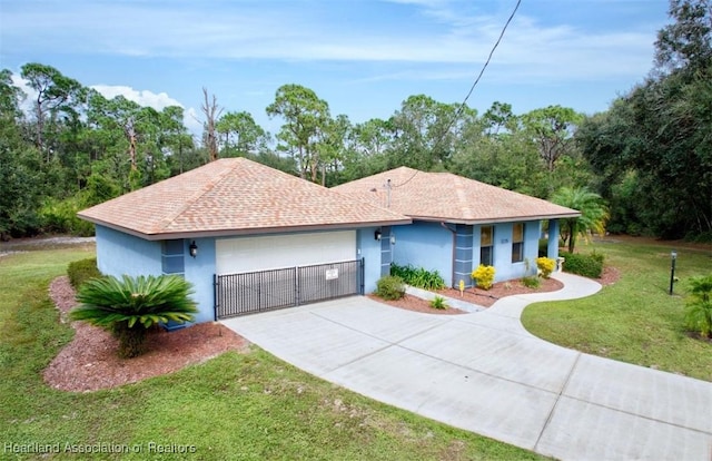 ranch-style house with a garage and a front lawn