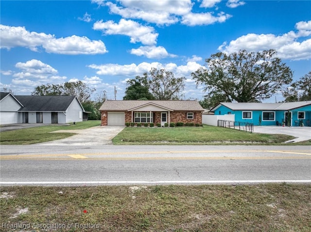 ranch-style house with a garage and a front yard