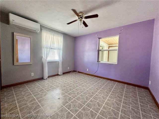 empty room with ceiling fan, a textured ceiling, and an AC wall unit