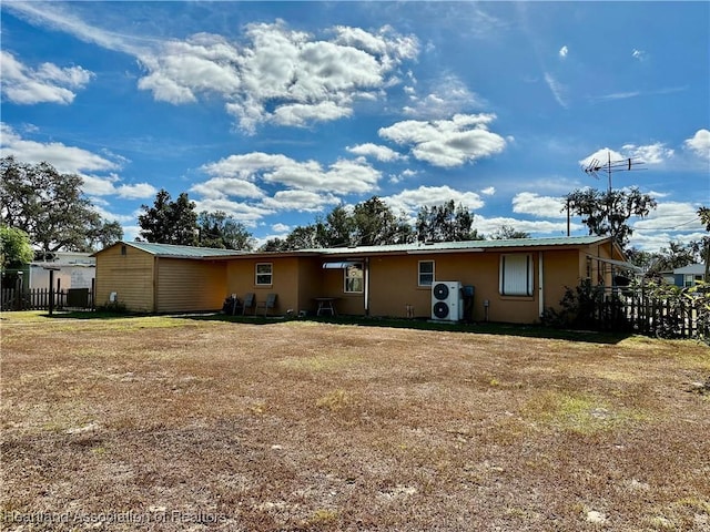 rear view of house featuring a lawn