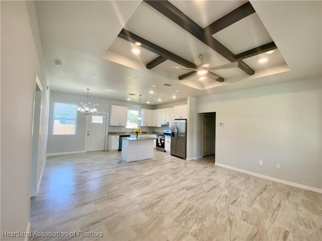 kitchen featuring ceiling fan with notable chandelier, stainless steel appliances, white cabinets, a center island, and hanging light fixtures