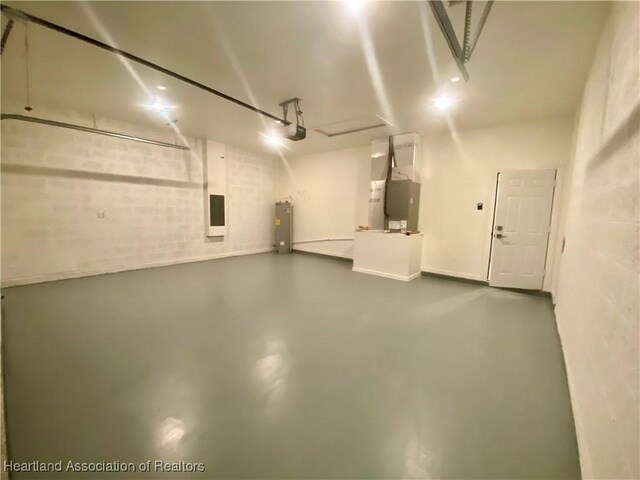 garage featuring heating unit, a garage door opener, and water heater