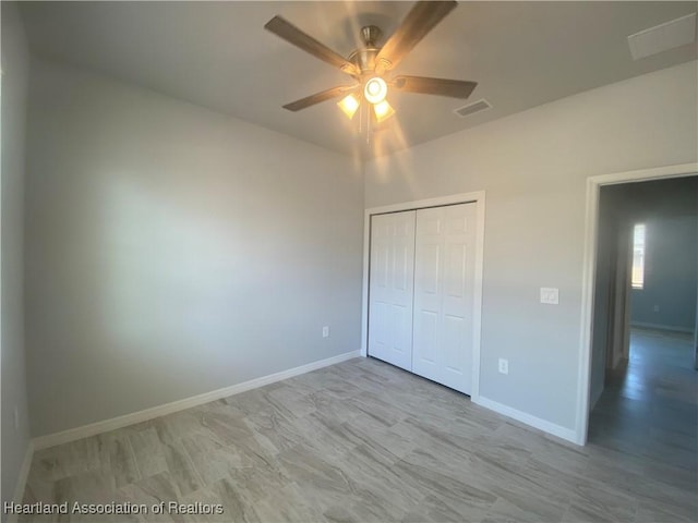 unfurnished bedroom with ceiling fan and a closet