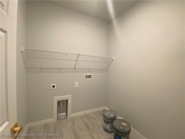 clothes washing area featuring wood-type flooring, washer hookup, and hookup for an electric dryer