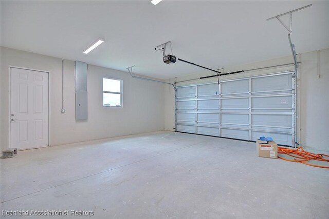 garage featuring a garage door opener and electric panel