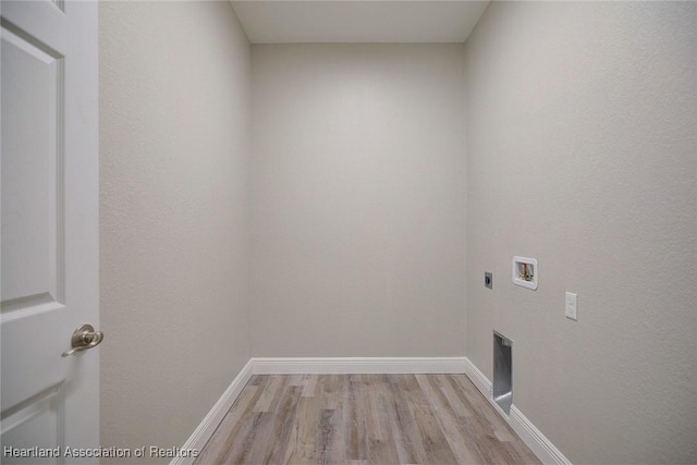 washroom featuring laundry area, baseboards, hookup for a washing machine, electric dryer hookup, and light wood-style flooring