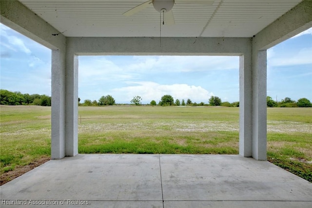 view of patio featuring ceiling fan and a rural view