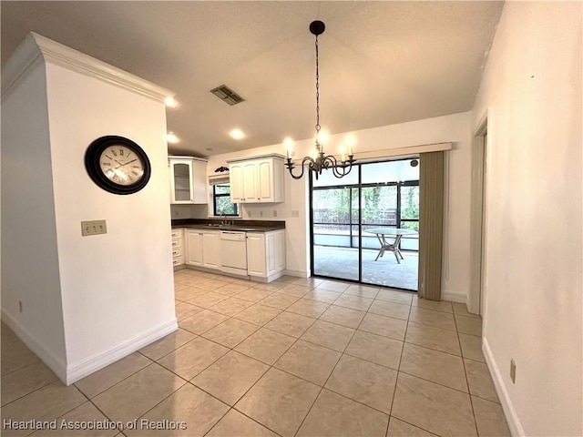 unfurnished dining area featuring a chandelier, visible vents, and baseboards