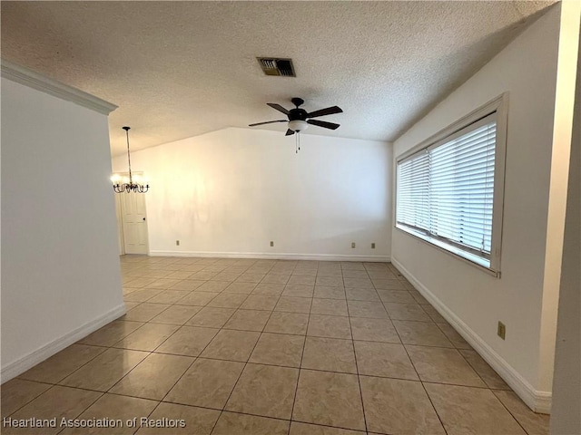 spare room with light tile patterned floors, lofted ceiling, visible vents, a textured ceiling, and ceiling fan with notable chandelier