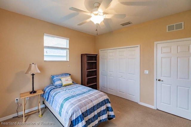 carpeted bedroom with ceiling fan and a closet